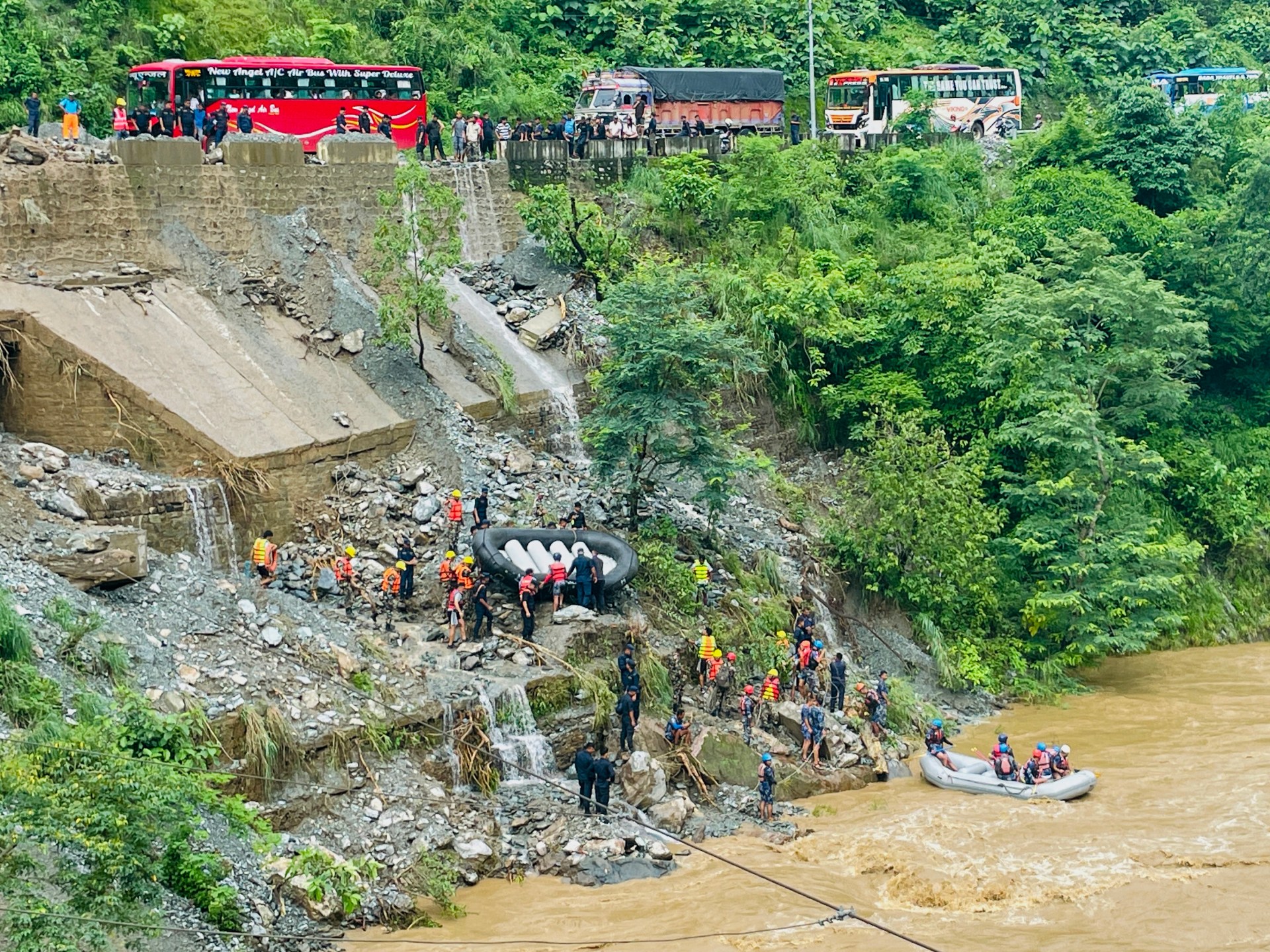 At least 60 people missing in a landslide tragedy that swept buses away