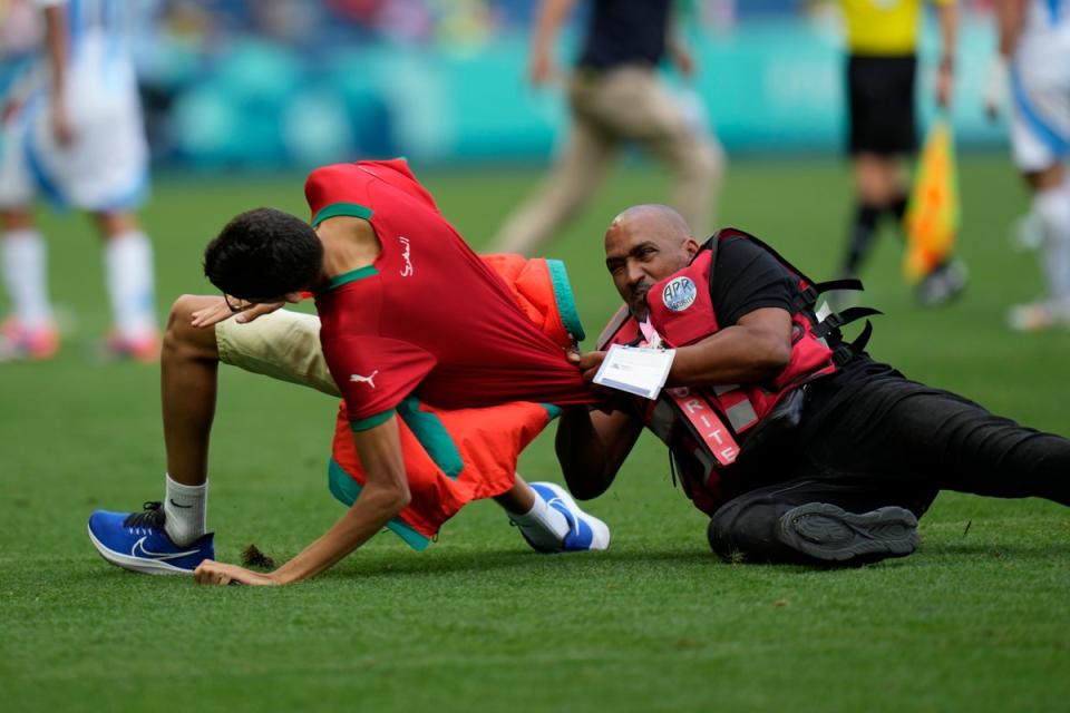 Fans storm pitch and throw bottles as Argentina v Morocco descends into chaos to kick off Olympics