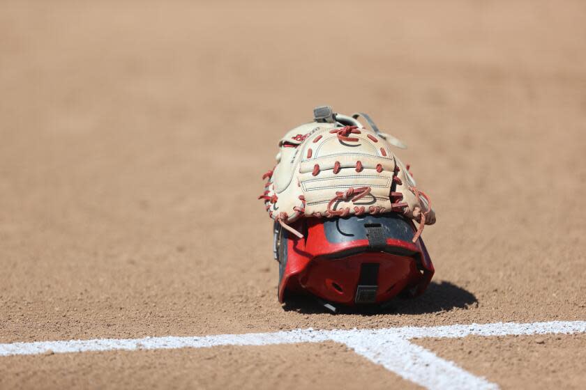 High school softball coaches will be allowed to use electronic devices to communicate with catchers