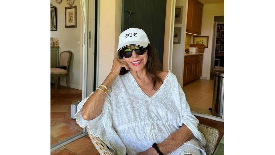 Joan Collins, 91, dances in plunging swimsuit during lavish holiday