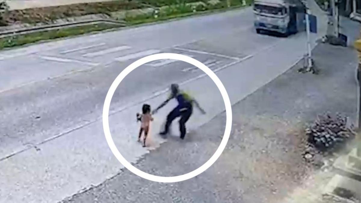 Old man tackles toddler before she runs into oncoming traffic