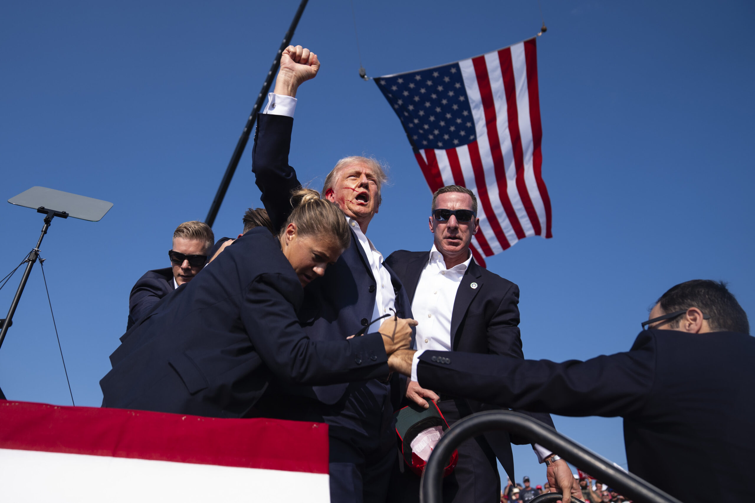 Photos show Trump with blood on his face after shots fired at rally