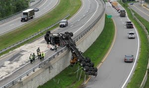 New Hampshire highway closed for hours after crash leaves logging truck hanging over wall