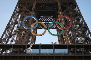 Police arrest a man climbing the Eiffel Tower, prompting an evacuation hours before closing ceremony