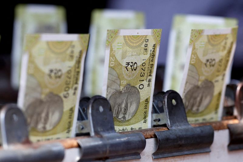 Rupee slips to record low as pressure from carry trade unwind lingers