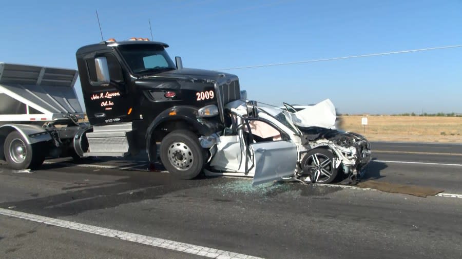 Semi-truck goes over back of sedan in 6-vehicle Madera County crash