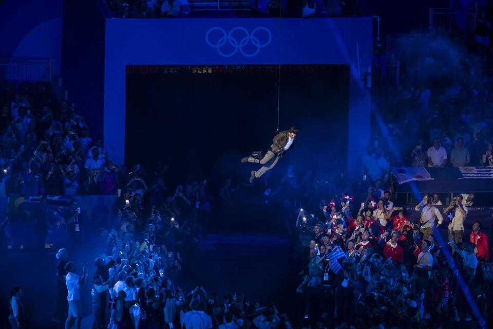 Tom Cruise’s Olympics closing ceremony stunt took over 1 year to plan. Here’s how it came together.