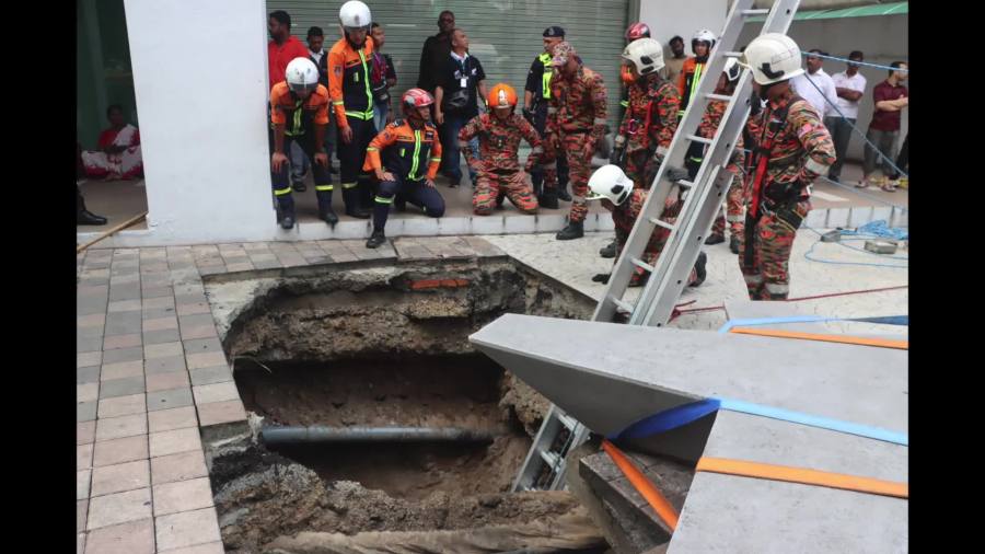 WATCH: Search continues after sidewalk sinkhole swallows Indian woman