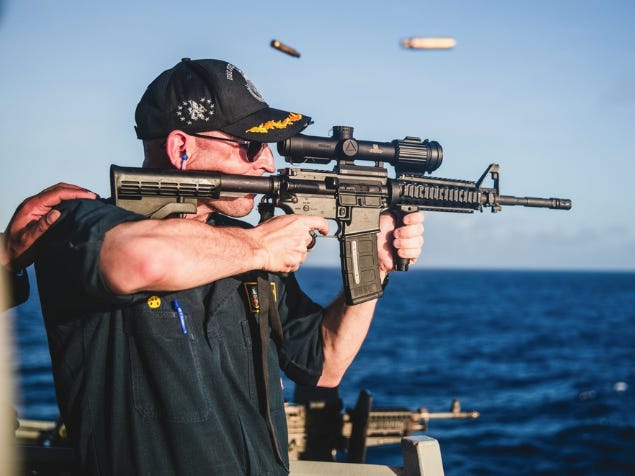 A US Navy warship commander was relieved of duty over a ‘loss of confidence’ 4 months after he was photographed firing a rifle with a backward scope