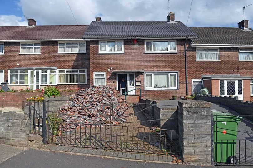 Roofers dump huge pile of rubbish outside man’s front door