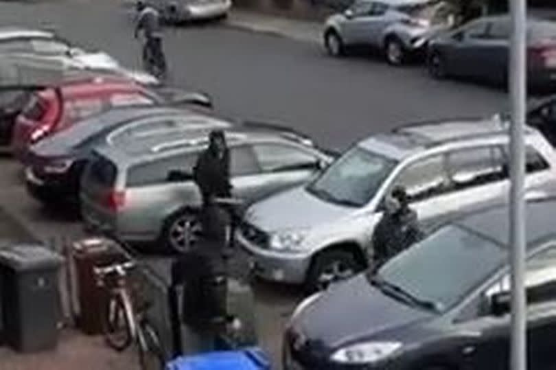 Horror footage shows masked thugs roaming street with huge crowbar amid ‘fight’ before fleeing in car