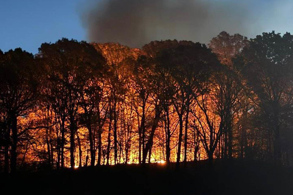 Wildfires rage across the Northeast amid warm, dry conditions