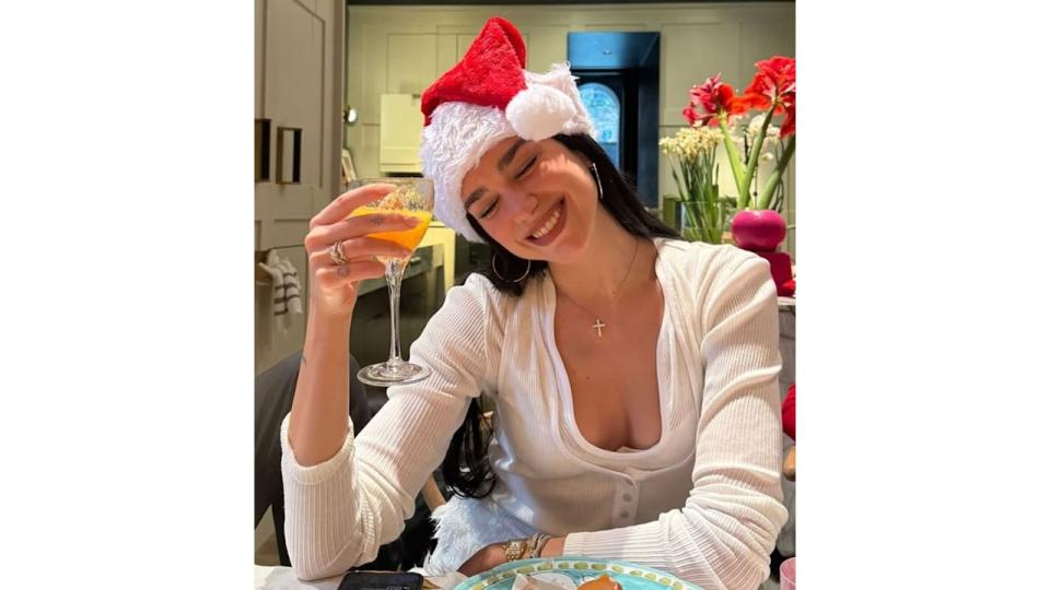 Dua Lipa shows off huge diamond engagement ring as she celebrates Christmas in micro-shorts