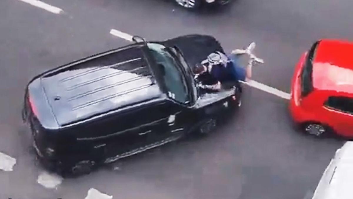 Hit-and-run driver tries to flee scene with cyclist hanging from car hood