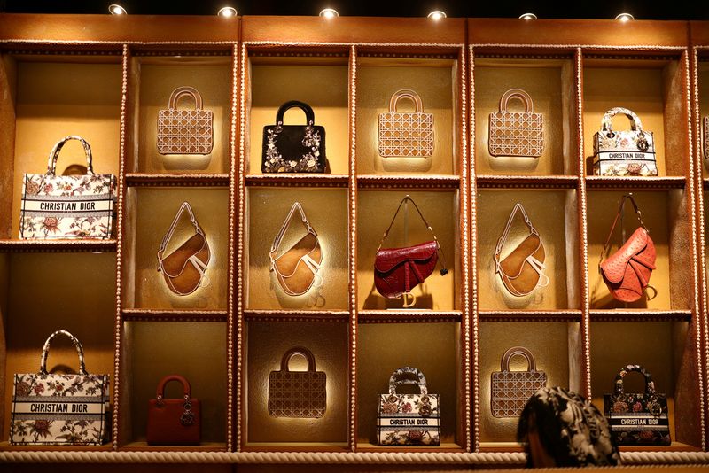 Luxury labels bulk up on lower-priced goods to appeal to middle-class shoppers