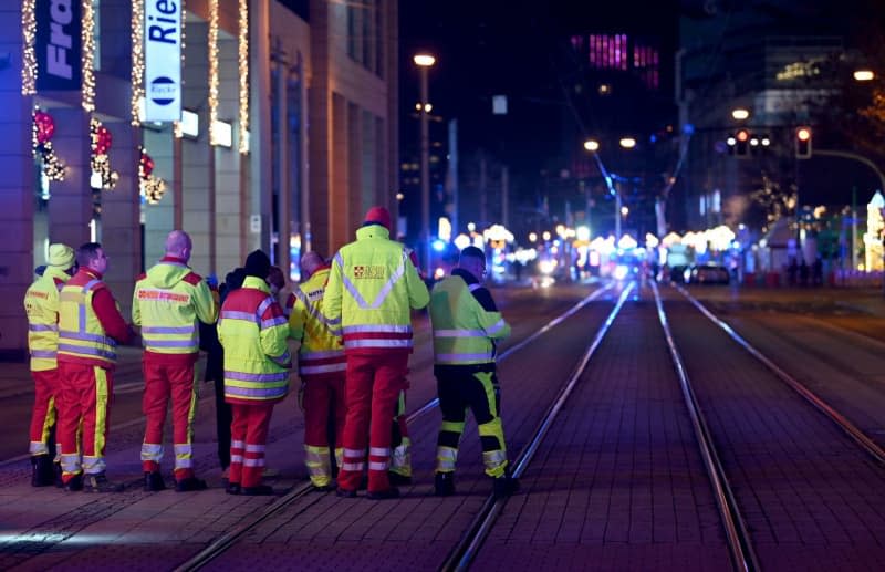 Medics treat injured in front of German Christmas market stalls