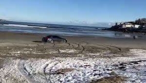 North Shore man facing charges after video shows car ‘doing doughnuts’ on beach, driving into ocean