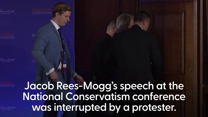 Protester dragged off stage during Jacob Rees-Mogg speech at National Conservatism conference