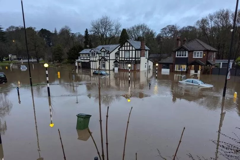 Cars abandoned as Bramhall Park Road roundabout completely submerged