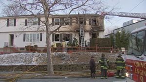 Firefighters battle flames, clutter in Quincy house fire that displaced 9