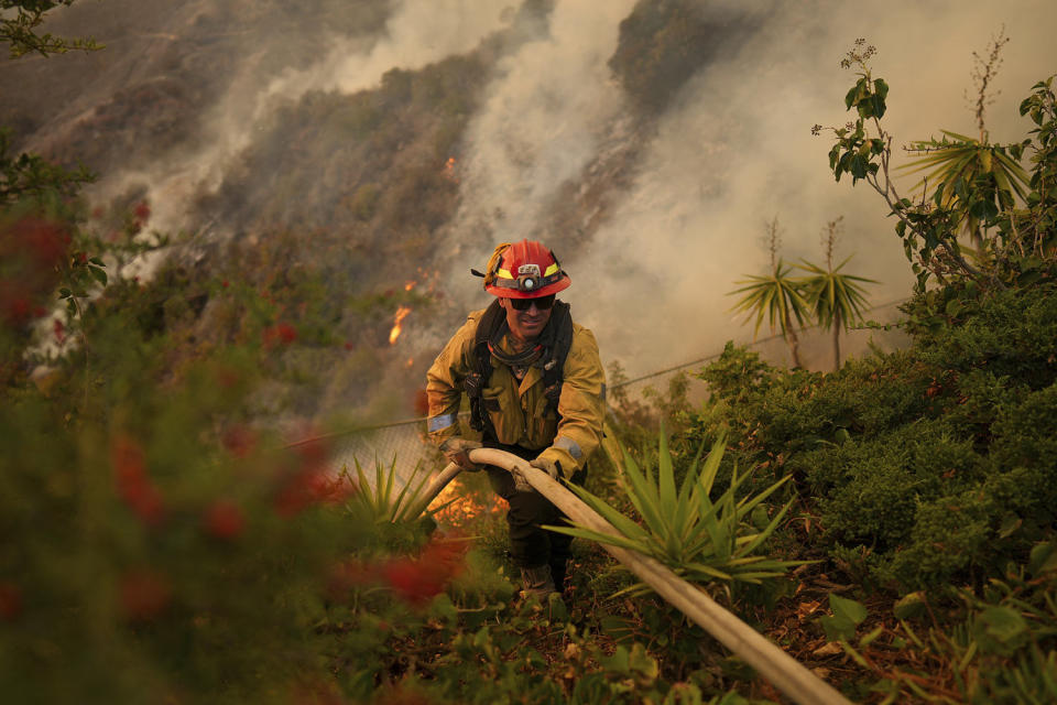 Firefighters battle to contain L.A. fires as Santa Ana winds are forecast to pick back up