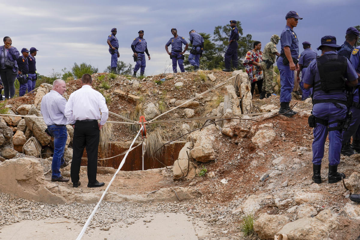 Rescuers attempt to bring out survivors among hundreds trapped in a South African mine