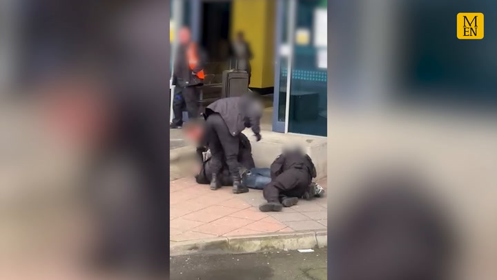 Video appears to show police kicking and hitting man as he is pinned to ground during arrest at Manchester Airport