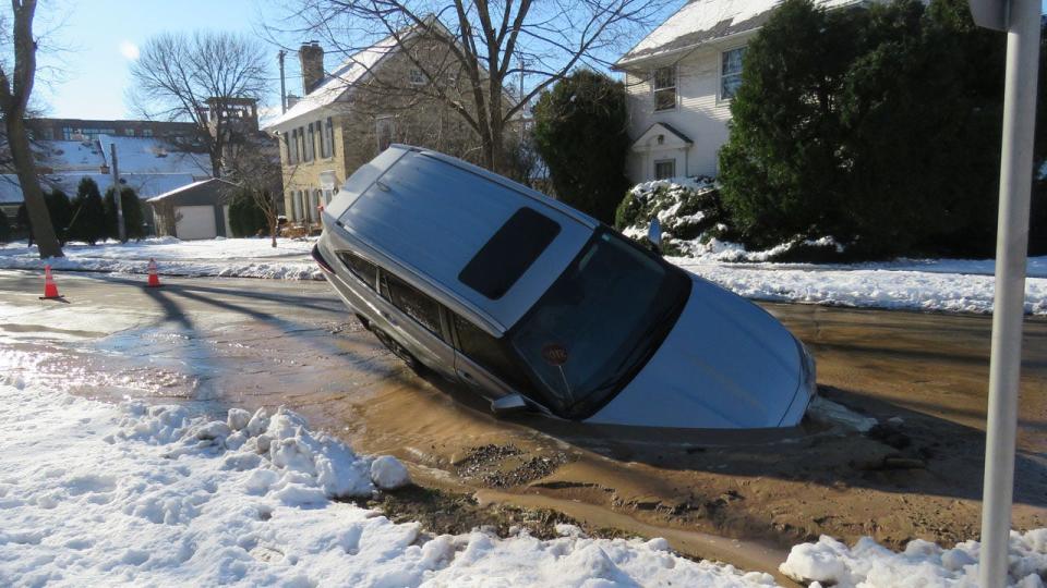 Whitefish Bay sinkhole; driver ignores road closure sign, roadway collapses