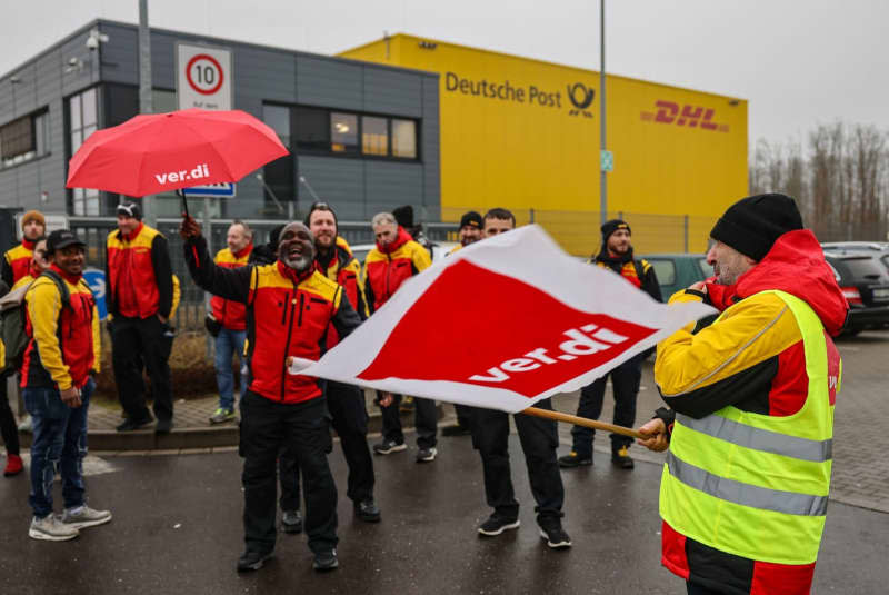 German postal workers threaten further strikes in wage dispute