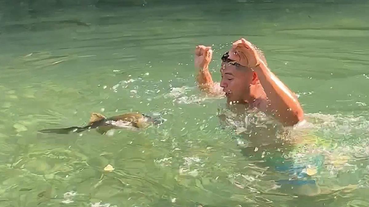 Nervous man scared out of river by hungry fish