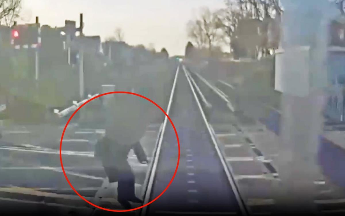 Watch: Woman ‘within half a second of being hit by train’